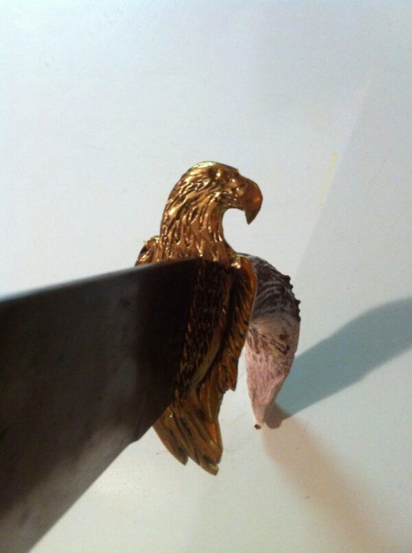 A picture of the brass eagle head on the knife