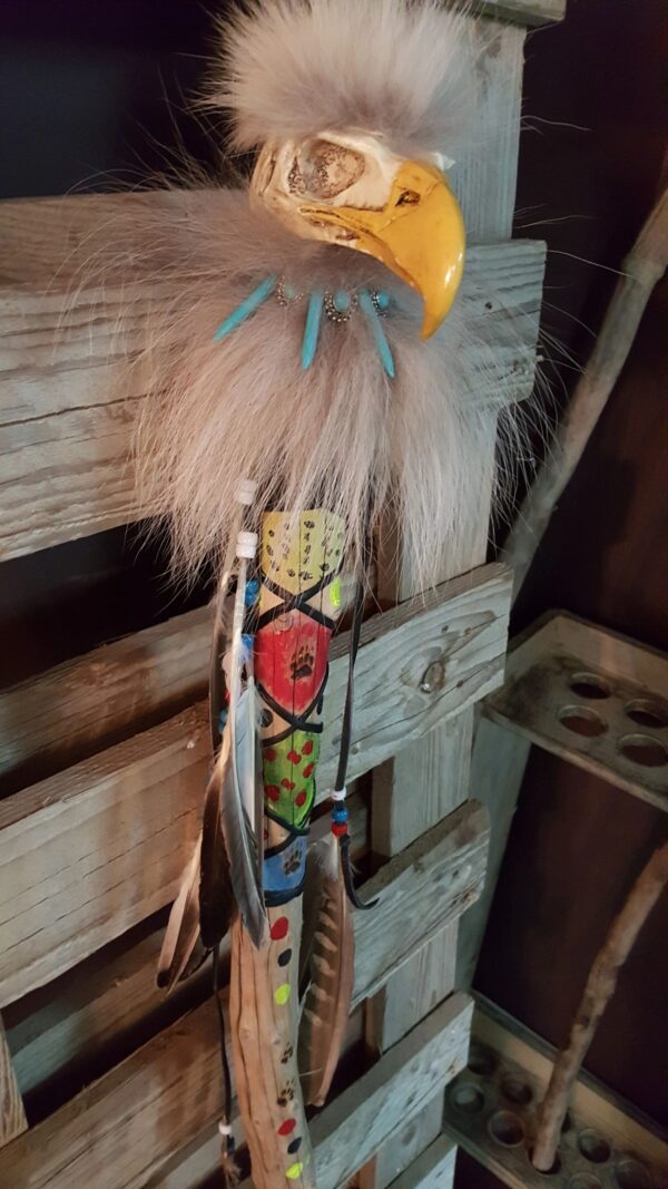 A 5 feet tall painted ceremonial walking stick with fur