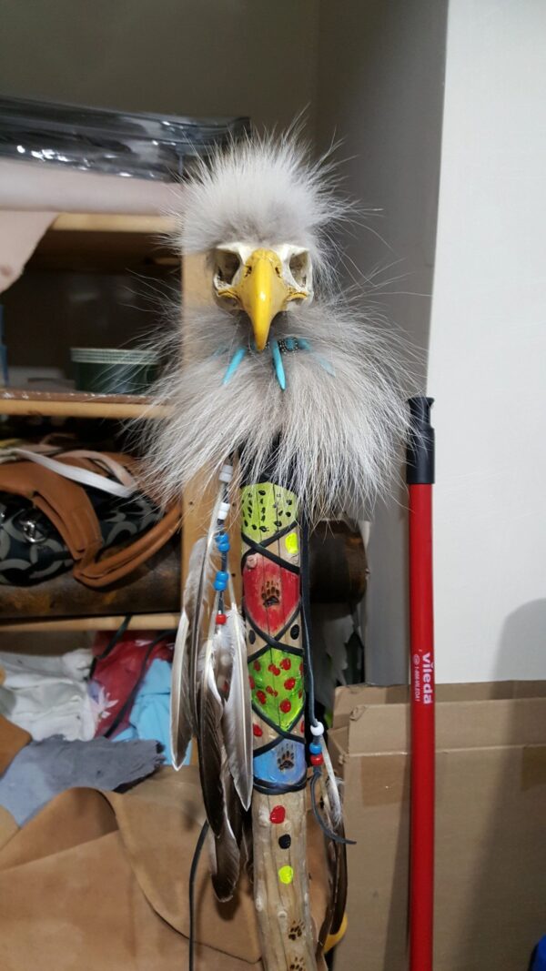 Painted ceremonial walking stick with hand carved eagle head on top